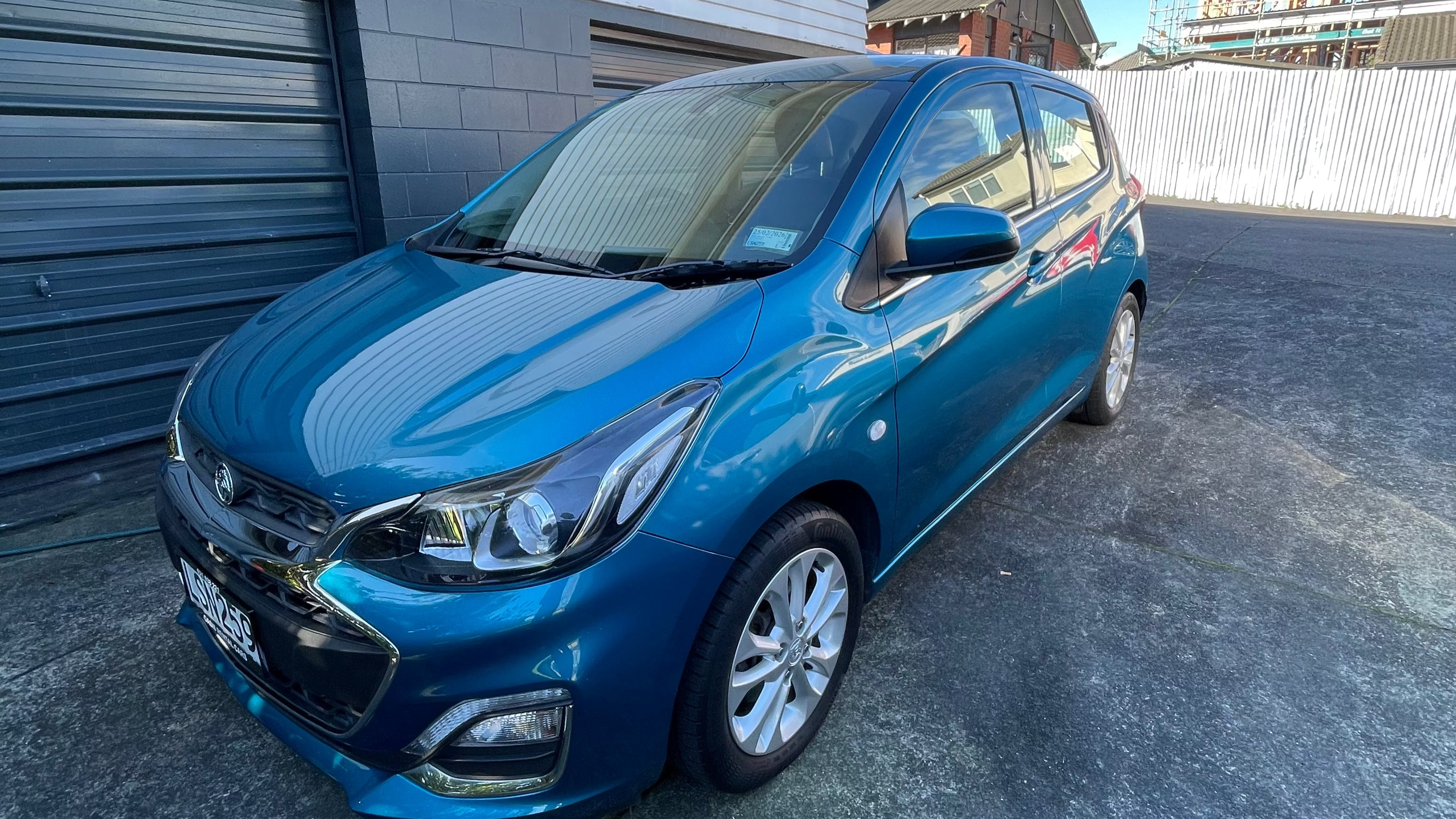 Holden Spark rental car showing headlights and modern grille