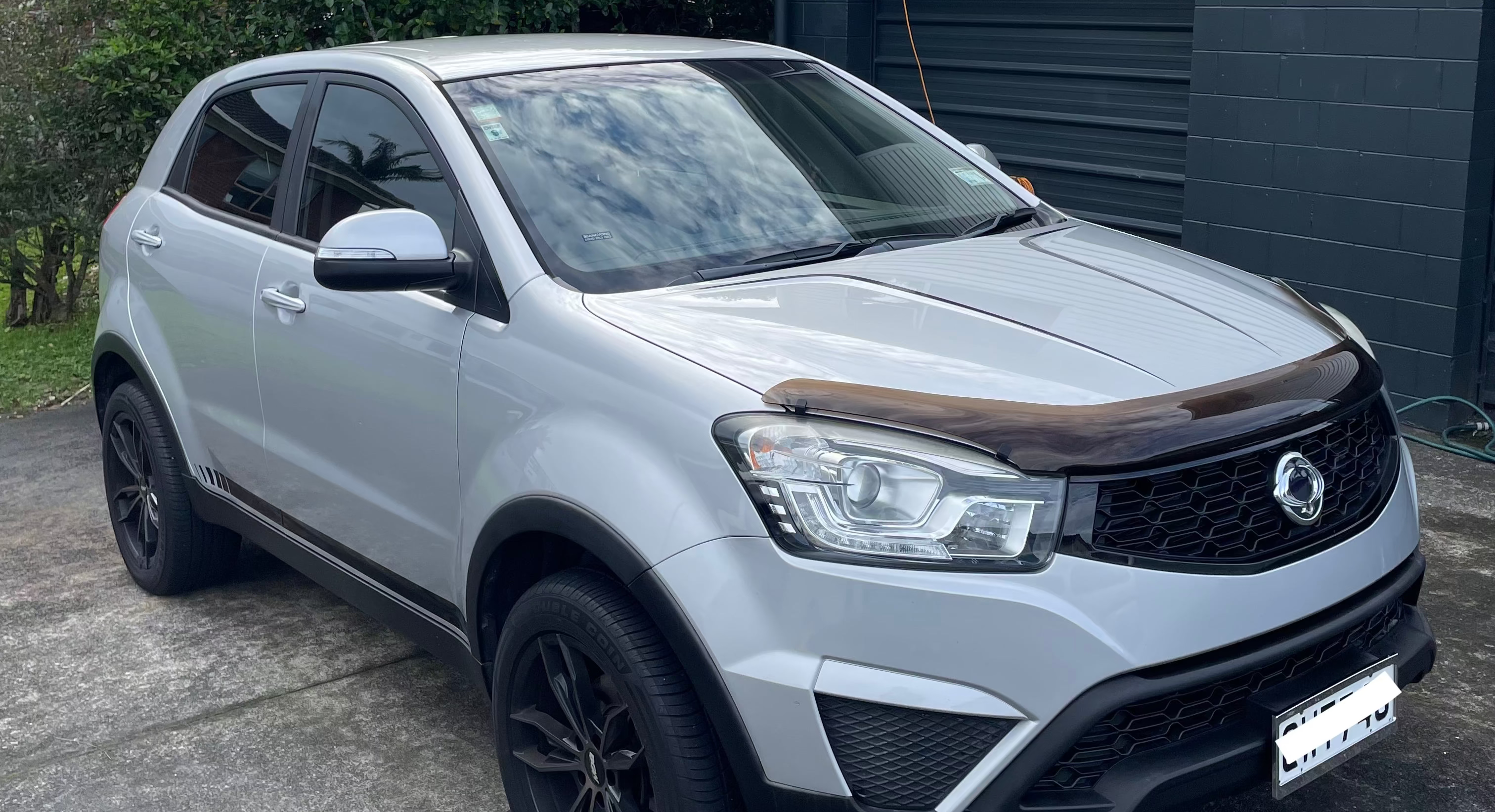  SsangYong Korando Sports SUV rental vehicle showing headlights and grille